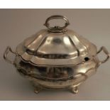 A late Victorian silver covered sauce tureen, of shaped oval form, engraved with a crest, raised