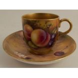 A Royal Worcester cabinet cup and saucer, the exterior of the cup and the saucer decorated with