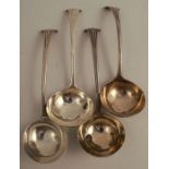 Four mid 18th century silver onslow pattern sauce ladles, two engraved with a crest, all bottom