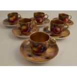 A set of six Royal Worcester coffee cups and saucers, decorated with fruit to a mossy background