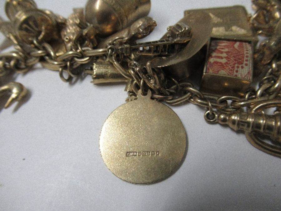 Nineteen hallmarked gold charms, three yellow metal charms, a 1912 heart sovereign and mount, all on - Image 5 of 6