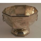 A silver octagonal pedestal bowl, with lion mask ring handles and reeded borders, Chester 1912,