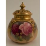 A Royal Worcester covered vase, with pierced gilt cover, the quarter lobed body decorated with