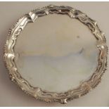 An 18th century silver salver, with ogee border, raised on three ball and claw feet, London 1759,