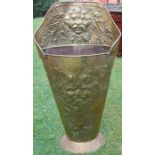 A 19th century brass grape hod, with embossed decoration of masks, leaves etc, of tapered oval form,