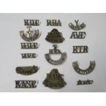 A large collection of brass regimental shoulder titles and badges, approximately 100 , to include