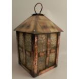 A large Arts and Crafts copper and brass hall lantern, with textured glass panels and faux tiled