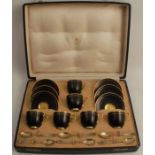 A cased set of six Royal Worcester coffee cups and saucers, in black and gold, with hallmarked