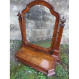 A Victorian figured walnut toilet mirror, having kingwood banding and obelisk shaped supports, and