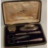 An Edwardian manicure set, with hallmarked silver mounted pot, nail buffer, file, nail cleaner and a