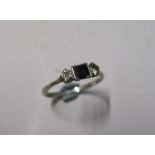 A sapphire and diamond three stone ring, stamped 'Plat', the rectangular cut sapphire flanked either
