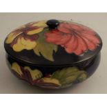 A Moorcroft covered shallow bowl, decorated in the Hibiscus pattern, impressed mark and paper