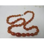 An amber coloured bead necklace