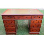 A 19th century mahogany pedestal desk, with tooled leather writing surface, having an arrangement of