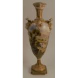 A Royal Worcester pedestal vase, the front decorated with a landscape by F Roberts, the back with