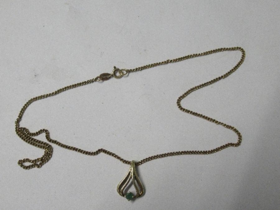 A 9 carat gold emerald pendant, on a chain, 4g gross