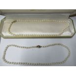 A uniform row of cultured pearls, to a 9 carat gold clasp, together with a graduated row to a 9