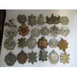 A quantity of military badges, predominantly from Scottish regiments, including Argyll &
