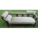 A late 19th century mahogany and upholstered chaise longue, with pierced carved uprights, raised