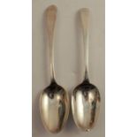 Two Irish mid 18th century silver serving spoons, one with bright cut decoration and engraved with a
