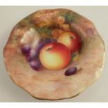 A Royal Worcester dish, with frilled edge, decorated with fruit to a mossy background by Moseley,