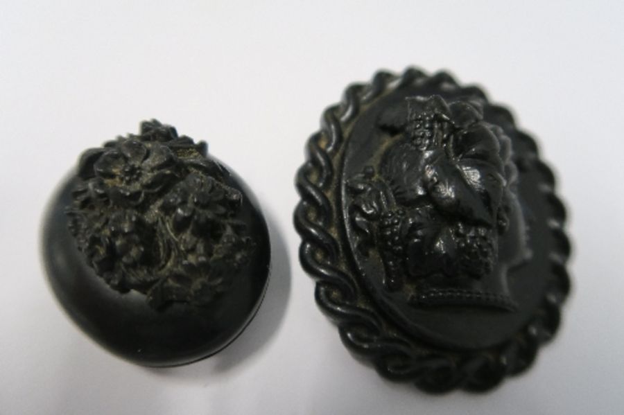 A cameo brooch, simulating jet, together with a locket