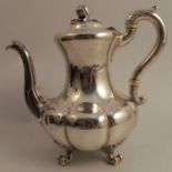 A Victorian silver coffee pot, of baluster form with shaped lower body, having a melon finial and