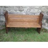 An oak church pew, width 63ins x height 39ins