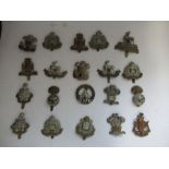 A quantity of British infantry military badges, to include The Suffolk Regiment, South Wales