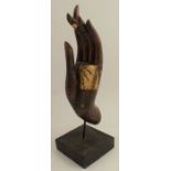 An Eastern painted wooden hand, with gilt decoration, on square base, overall height 16.5ins