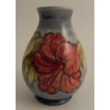 A Moorcroft vase, decorated in the Hibiscus pattern, impressed mark the base, height 5.5ins