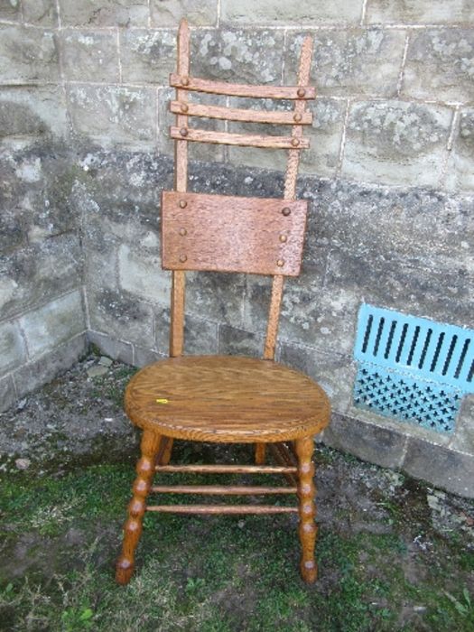 An unusual Arts and Crafts style high ladder back oak chair, max height 49ins, seat width 19ins