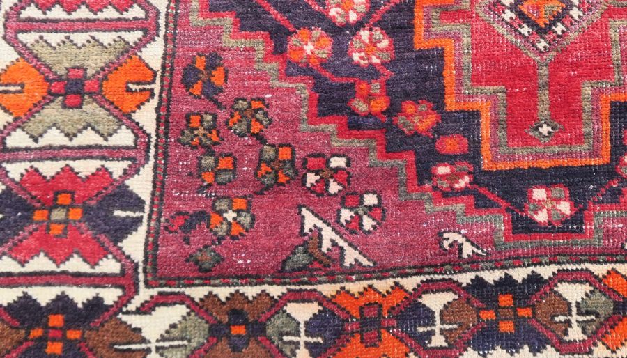 An Eastern style rug, the red ground decorated with repeating symbols, 55ins x 80ins - Image 2 of 3