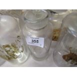 A quantity of  apothercary glass jars and stoppers, some labelled