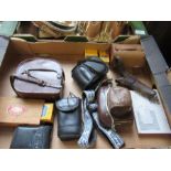 A box containing cameras, binoculars, film, etc.