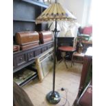 A metal lamp standard, with Tiffany style leaded glass shade, height 62ins