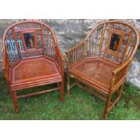 Two Oriental design bamboo effect armchairs, with lacquered panel and cane seats