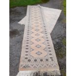 An Eastern design runner, 32ins x 126ins, together with a similar Eastern rug, 50ins x 72ins