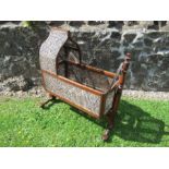 A Victorian mahogany and bergere framed cot, damage to the cane, maximum height 44ins x length