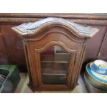 A small oak cased display cabinet, the door opening to reveal shelves, height 18ins x width 17ins