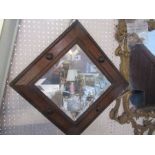 An oak framed wall mirror, with carved and applied decoration, with bevelled glass plate, overall