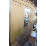 A pine mirror door wardrobe, fitted with two drawers to the base, width 66ins, height 80ins