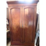 A Victorian mahogany double door wardrobe, fitted with a hanging space and drawer to one side,