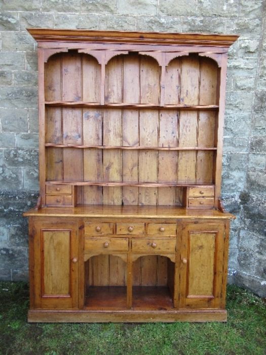 A pine dresser, with arcaded upper section, width 70ins x depth 16ins x height 84ins