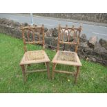 A pair of Gothic design cane seated chairs, both seats the cane is damaged