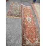 An Eastern style runner, with orange ground field, 30ins x 100ins, together with another rug,