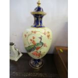 A Royal Worcester covered pedestal vase, the ivory body decorated with a peacock to the front and