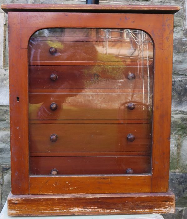 A table top set of drawers, having a glazed door, with six drawers, 15ins x 10.25ins, height 18ins