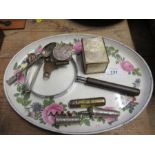 A porcelain dressing table tray of oval form, together with a brass cased spirit level, a corkscrew,