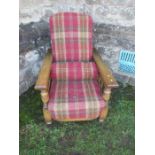 An oak framed steamer chair, with tartan upholstery